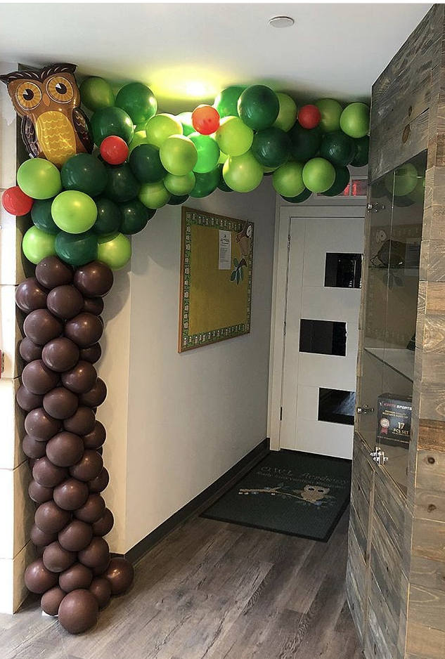 A palm tree made out of balloons in the hallway.