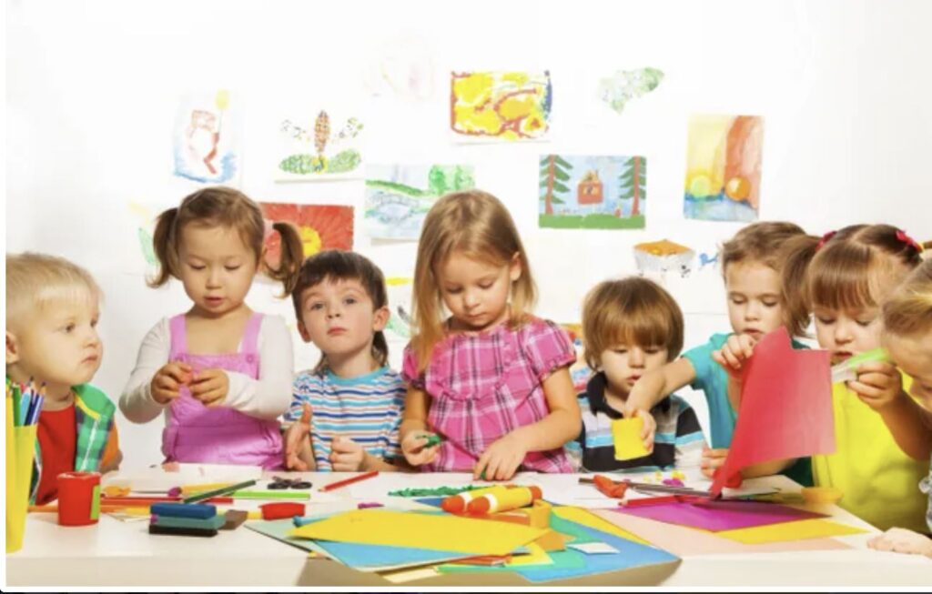 A group of children sitting around a table.