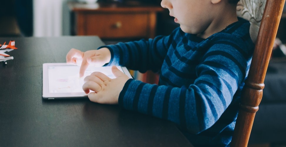 A child is playing on an ipad